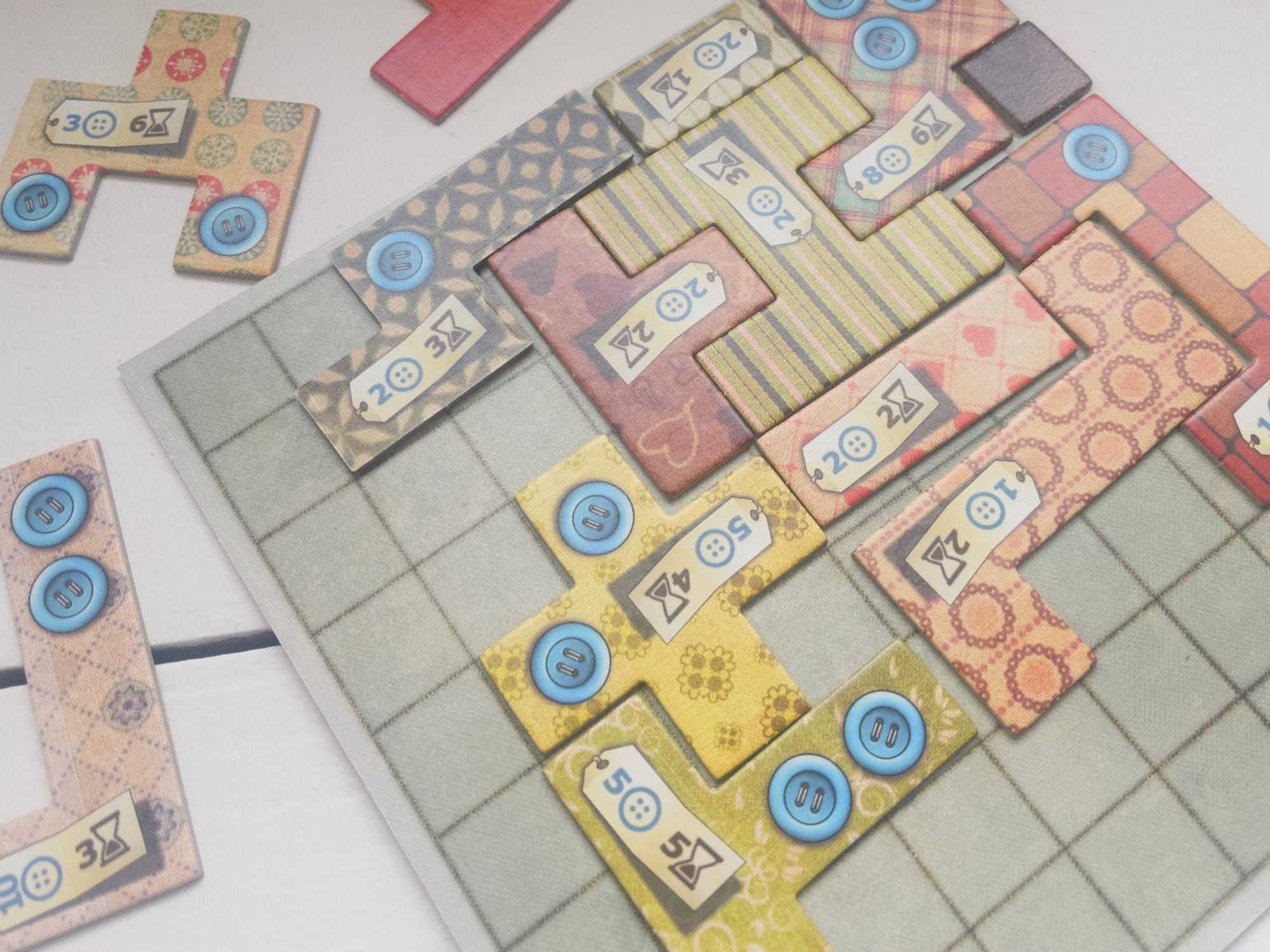 A 10x10 grid board partially covered by irregularly-shaped patchwork pieces.